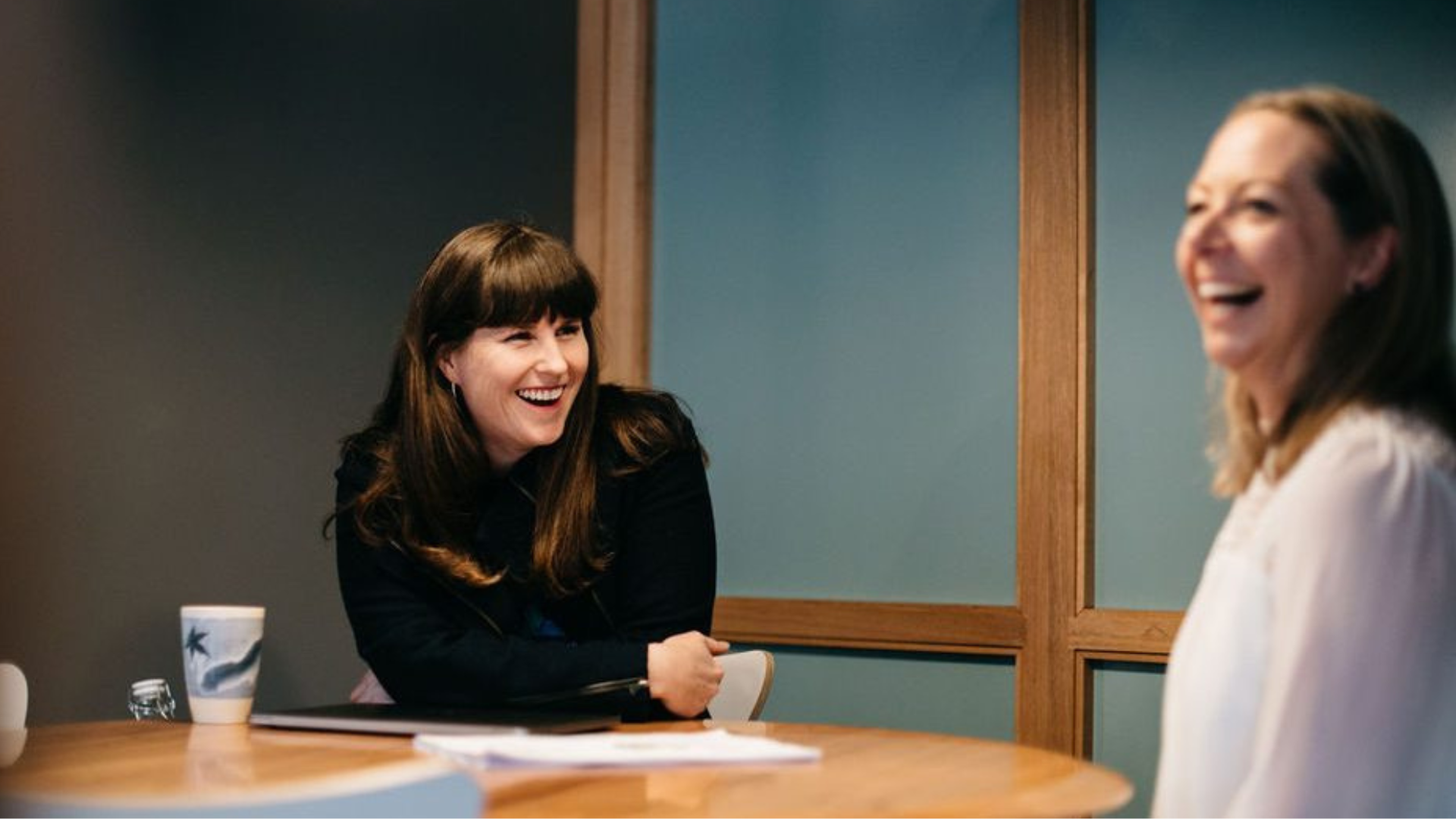 Kirsty Dunphey laughing during a mentoring conversation across a table