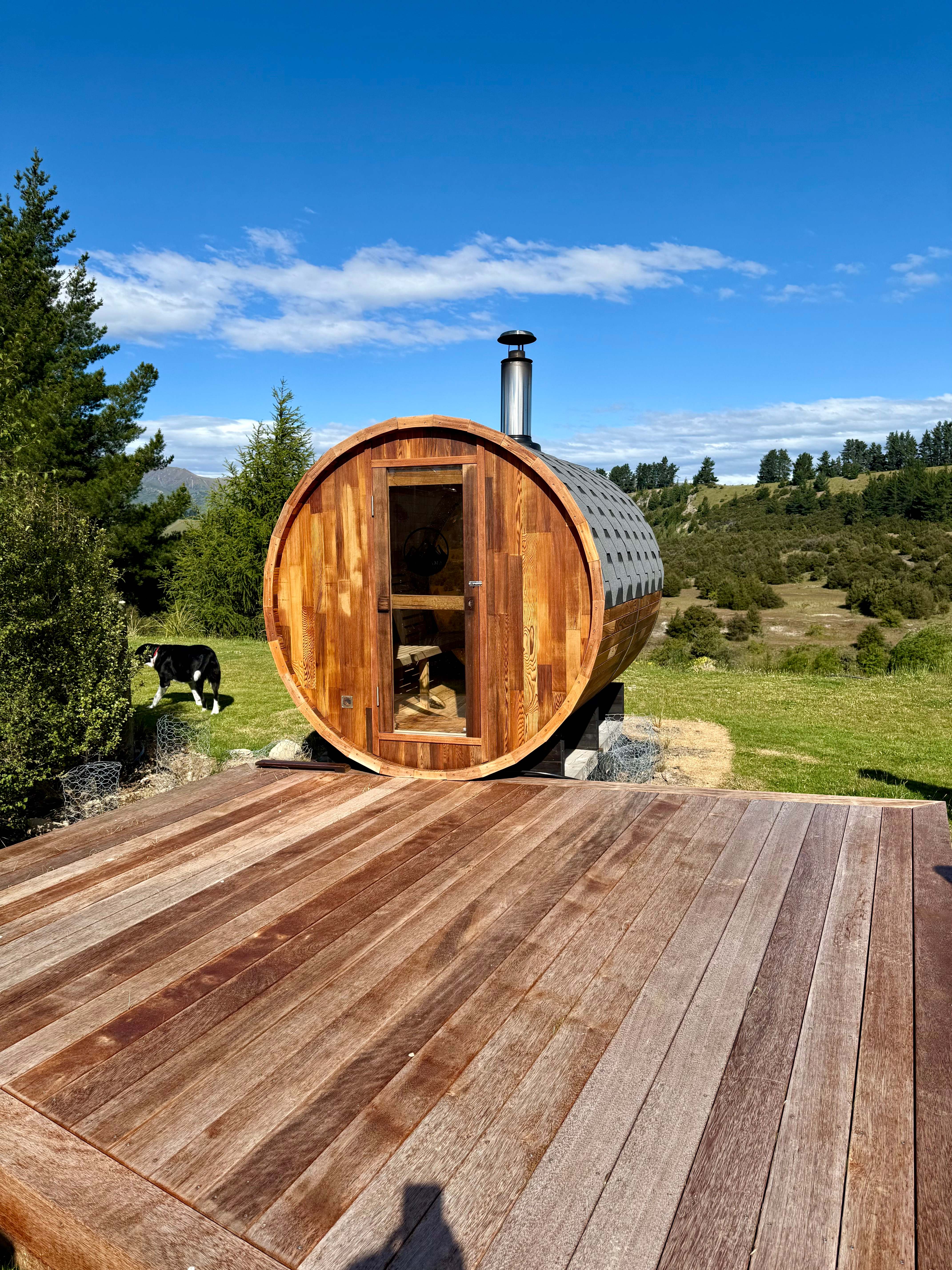 A cedar barrel sauna on a deck in the New Zealand high country
