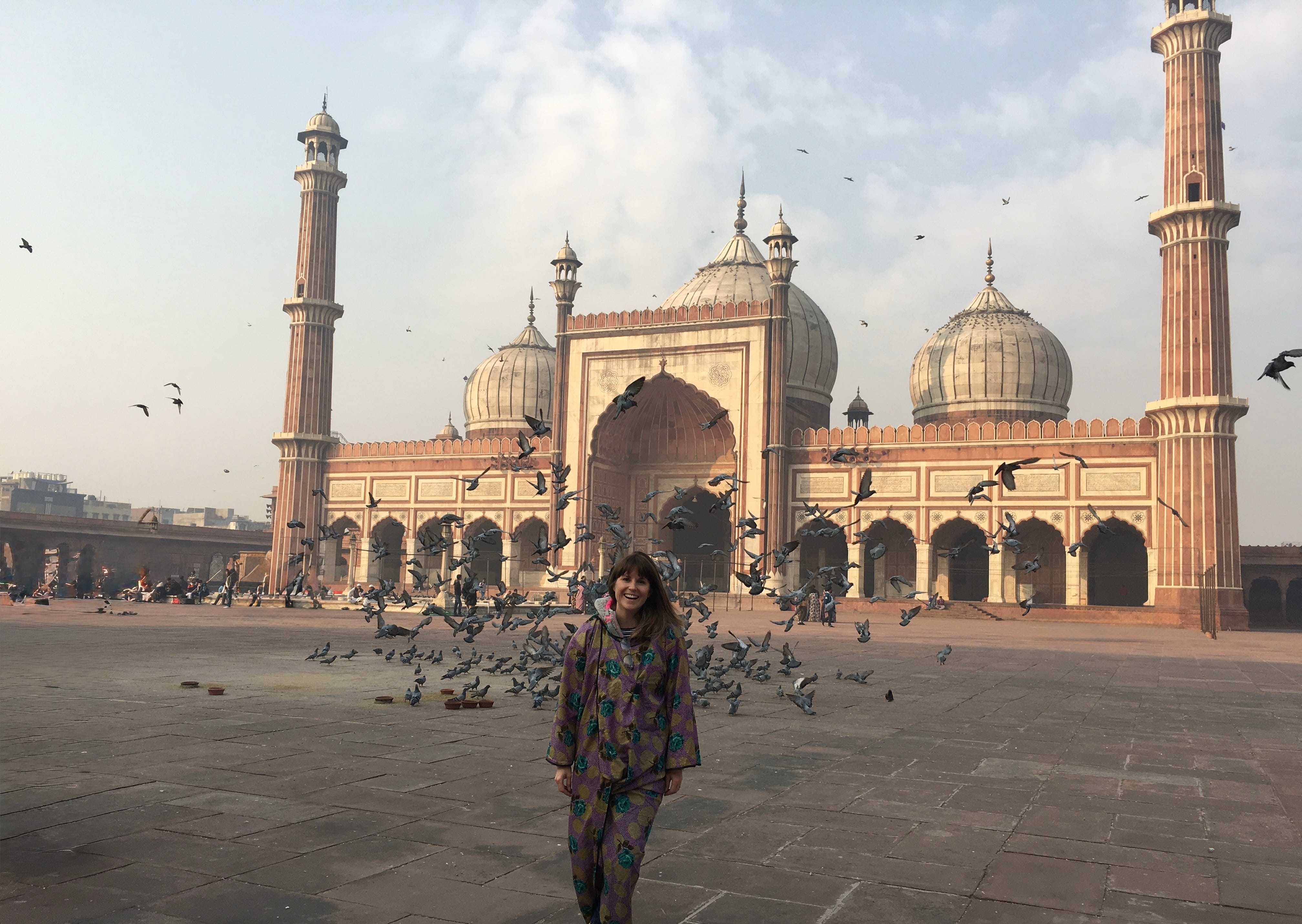 Kirsty Dunphey in the courtyard of the Jama Masjid in Delhi as pigeons take flight